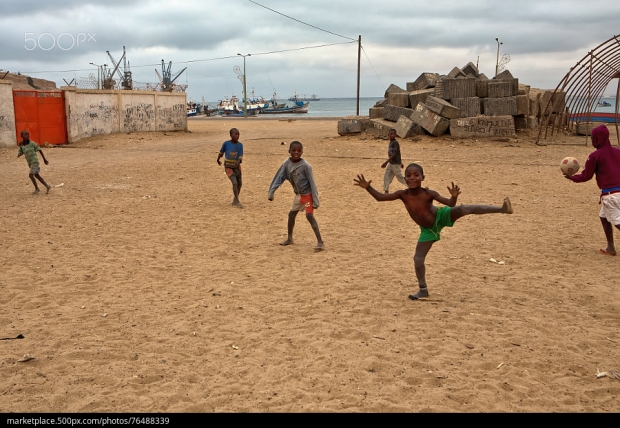 500px Photo ID: 76488339 - boys are playing football near the ocean, Angola